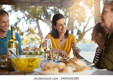Happy family, eating and food with laughing outdoor on patio with funny conversation, bonding and healthy lunch. People, dinner and relax at dining table in backyard of home with supper and talking - Powered by Shutterstock