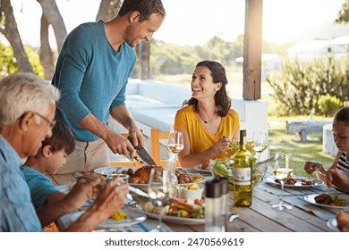 Happy family, eating and food with laughing outdoor on patio with funny conversation, bonding or healthy lunch. Parents, grandparents and kids at dining table in backyard of home with love or talking - Powered by Shutterstock