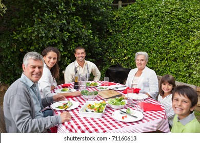 Happy Family Eating In The Garden