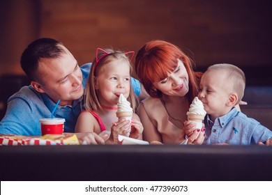 Happy Family Eating Ice Cream In Restaurant