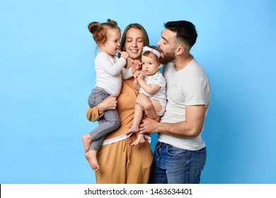 Happy Family Eating Lollipop While Standing Over Blue Background. Studio Shot. Close Up Portrait. Happiness, Love,strong Relationship