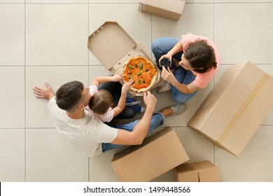 Happy Family Eating Pizza On Moving Day