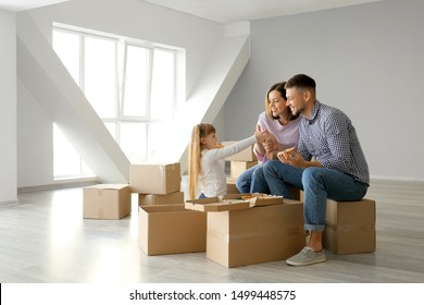 Happy Family Eating Pizza On Moving Day