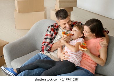 Happy Family Eating Pizza On Moving Day