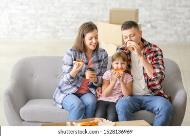 Happy Family Eating Pizza On Moving Day