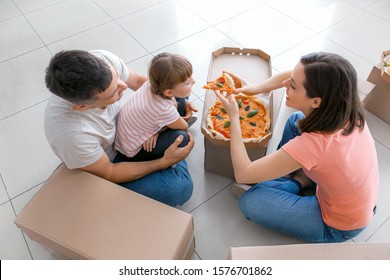 Happy Family Eating Pizza On Moving Day