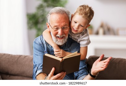 Happy family elderly  man and little boy smiling r while sitting on couch and reading fascinating fairy tale together at home
 - Powered by Shutterstock