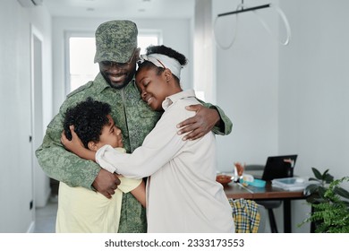 Happy family embracing their father, they meeting him from military service - Powered by Shutterstock