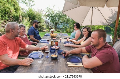 Happy Family Enjoy Barbecue Dinner On Patio - Multi Generational People Enjoy Summer Day Outdoor