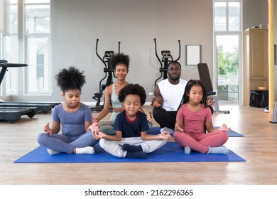 Happy Family Enjoy Holiday Together In Fitness Center. Meditating On Yoga Mat Before Exercise. Morning Fitness, Mindfulness Concept.