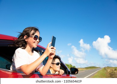 Happy Family Enjoy Road Trip Taking Picture By Smart Phone