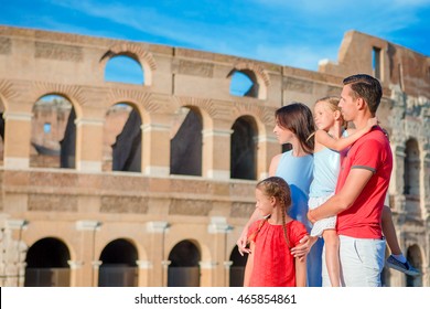 Happy Family Enjoy Their Vacation On Colosseum Background. Italian European Vacation Together In Rome