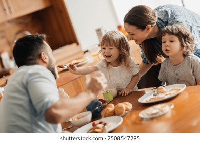 Happy family enjoying breakfast together in cozy kitchen - Powered by Shutterstock