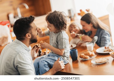 Happy family enjoying breakfast together in cozy kitchen - Powered by Shutterstock