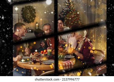 Happy Family Enjoying Festive Dinner At Home, View Through Window. Christmas Celebration