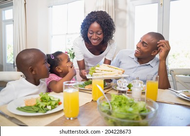 Happy Family Enjoying A Healthy Meal Together At Home In The Kitchen