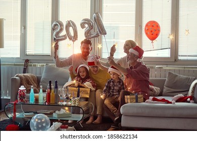 Happy Family Enjoying New Year Eve In Home Festive Atmosphere Together. New Year, Holiday, Family Time Together