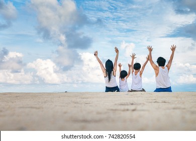 Happy Family Enjoying On The Beach At The Sea During Vacation.Asia Traveler Relaxing On Free Time.