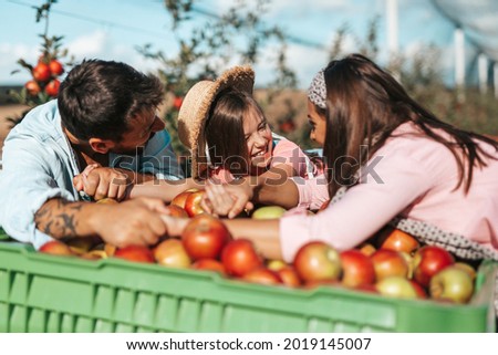 Similar – Image, Stock Photo Children and senior woman putting apples inside of wicker baskets