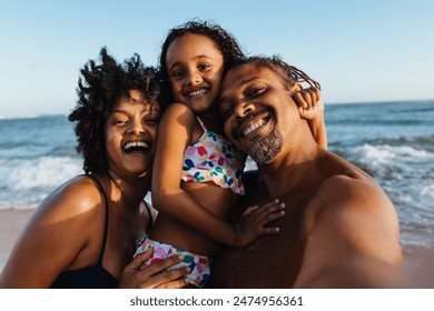 Happy family enjoying a vacation at the beach, capturing a selfie with smiles and joy. Perfect summer moment with loved ones. - Powered by Shutterstock