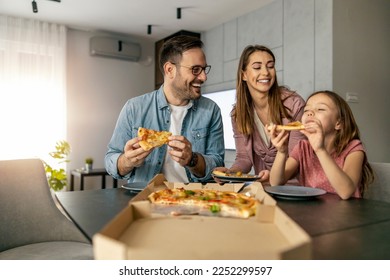 Happy family enjoying in weekend together.Happy family concept.They are eating pizza for lunch. - Shutterstock ID 2252299597
