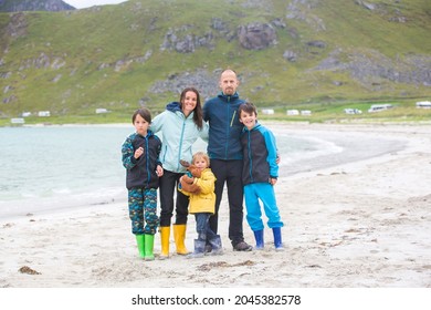 Happy Family, Enjoying White Sand Beaches In Lofoten, Norway On A Summer Cold Rainy Day, Family Concept