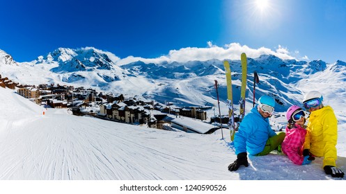 Happy Family Enjoying Winter Vacations In Mountains, Val Thorens, 3 Valleys, France. Playing With Snow And Sun In High Mountains. Winter Holidays.