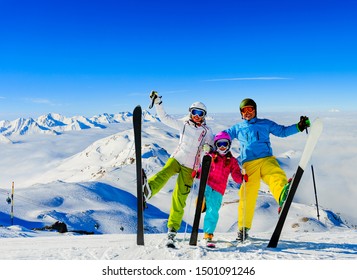 Happy Family Enjoying Winter Vacations In Mountains, Val Thorens, 3 Valleys, France. Playing With Snow And Sun In High Mountains. Winter Holidays.