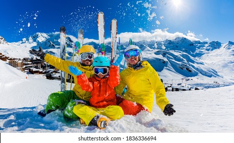 Happy family enjoying winter vacations in mountains, Val Thorens, 3 Valleys, France. Playing with snow and sun in high mountains. Winter holidays.