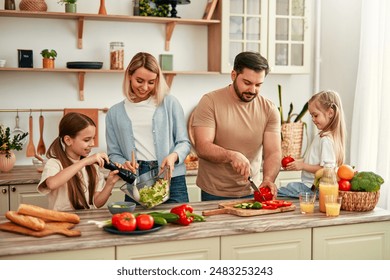 The happy family enjoys bonding and quality time cooking a nutritious meal together in their modern, bright kitchen, reflecting their close household and lifestyle - Powered by Shutterstock