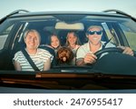 Happy family enjoys road trip together, with fluffy brown Maltipoo dog in front seat and two young girls in back. Scene captures the joy and warmth of family outing in their car
