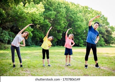  Happy Family Exercising  Together At The Park