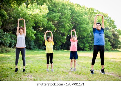  Happy Family Exercising  Together At The Park