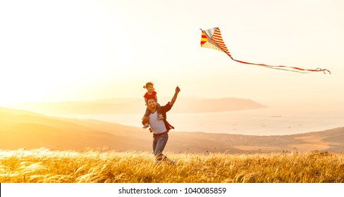 Happy Family Father And Child Daughter Run With A Kite On Meadow