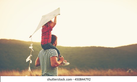 happy family father and child on meadow with a kite in the summer on the nature - Shutterstock ID 450844792