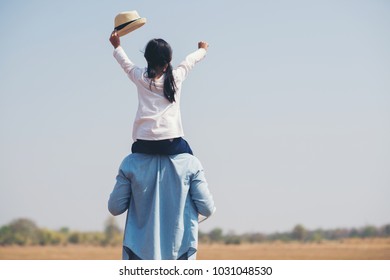 happy family of father, children, baby girl and daughter on the travel in summer. The child sits on the shoulders of his father. - Shutterstock ID 1031048530