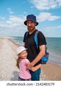 Happy Family Father Daughter Hugging On Marine Landscape. Bearded Dad With Child In Hands Having Fun Together Looking On Sea Water. Authentic Lifestyle Real People. Travel Fathers Day Southern Ukraine