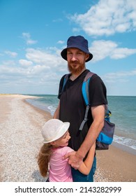 Happy Family Father Daughter Hugging On Marine Landscape. Bearded Dad With Child In Hands Having Fun Together Looking On Sea Water. Authentic Lifestyle Real People. Travel Fathers Day Southern Ukraine