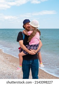 Happy Family Father Daughter Hugging On Marine Landscape. Bearded Dad With Child In Hands Having Fun Together Looking On Sea Water. Authentic Lifestyle Real People. Travel Fathers Day Southern Ukraine