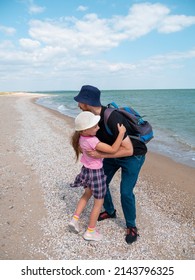 Happy Family Father Daughter Hugging On Marine Landscape. Bearded Dad With Child In Hands Having Fun Together Looking On Sea Water. Authentic Lifestyle Real People. Travel Fathers Day Southern Ukraine