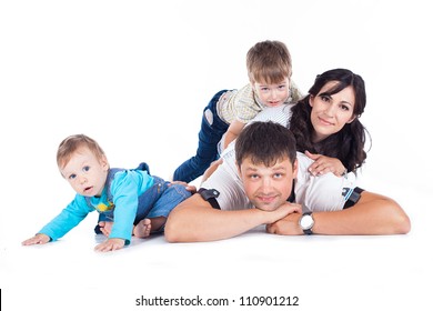 Happy family father and mother with children posing in the studio on a white background. A series of photos in my portfolio.