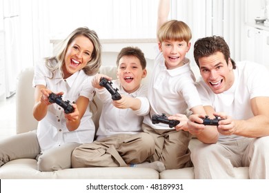 Happy Family. Father, Mother And Children Playing A Video Game