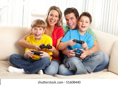 Happy Family. Father, Mother And Children Playing A Video Game