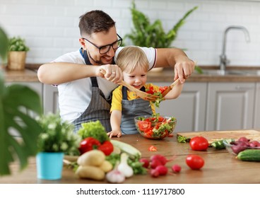 happy family father with son  preparing vegetable salad at home
 - Powered by Shutterstock