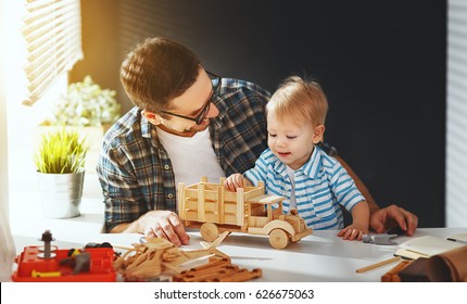 Happy Family Father And Son Toddler Gather Craft A Car Out Of Wood And Play
