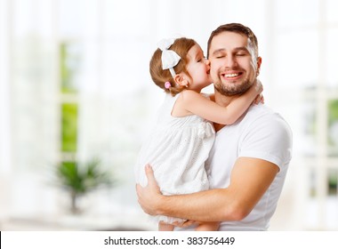 Happy Family And Father's Day. Child Daughter Kissing And Hugging Dad