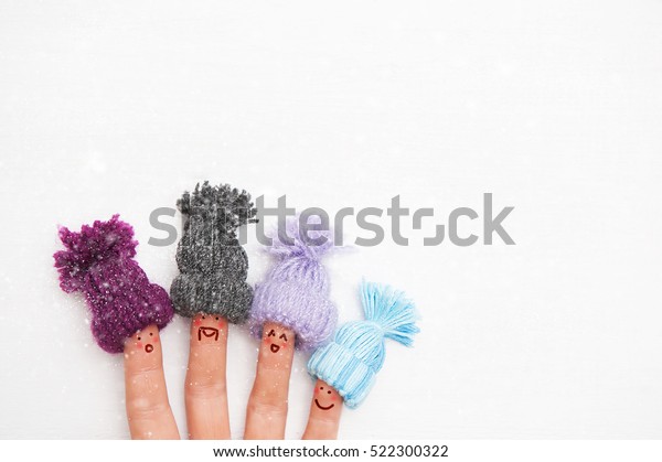 happy family fingers in warm knitted hats
with bubonic rejoices first winter
snow.