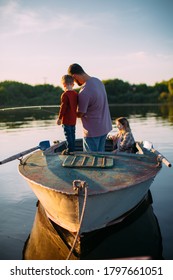 Happy Family Fishing On Boat In Summertime. Father Teaches Son Fishing. Back View. Photo For Blog About Family Travel