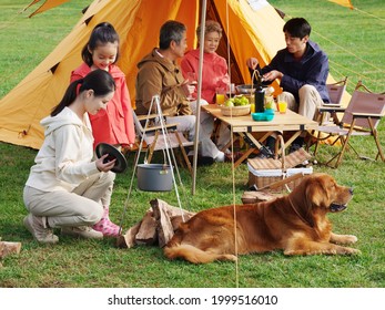 Happy family of five and pet dog have a picnic outdoors high quality photo - Powered by Shutterstock