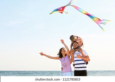 Happy Family Flying Kite Near Sea